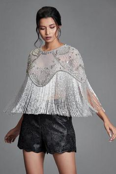 Grey sheer cape with crystal and bead embroidered floral motifs.
Components: 1
Fabric: Tulle
Neckline: Round
Sleeve Length: Asymmetric
Color: Grey
Embroidery
Hand embroidery
Cutdana tassel detail on hem
Note: Shorts worn by model is not for sale. - Aza Fashions Cape Women, Cape For Women, Embroidered Cape, Trendy Blouse, Indian Bridal Dress, Draped Skirt, Simple Pakistani Dresses, Fashionista Clothes, Pinterest Fashion