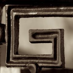 a close up of a metal object with square and rectangle shapes