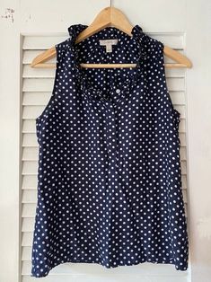 "Sleeveless dark blue/white polka dot silk blouse with ruffle collar, size 2, gently used.  Button closure on front, from top to half way down. Length from back of neck - 23\" Chest - 36\" *Note this is a second hand product. Order takes one day to process before shipping." Garment Labels, Ruffle Collar, White Polka Dot, Silk Blouse, Washington Dc, Womens Clothing Tops, One Day, Polka Dot, Dark Blue