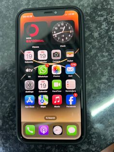 an iphone is sitting on a table with various app icons and symbols in the display