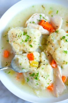 a white bowl filled with chicken and dumplings