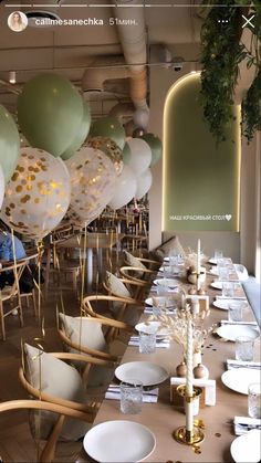 a long table with balloons and plates on it