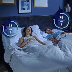 two people laying in bed with thermometers showing