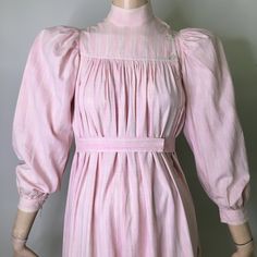 "This is a antique wrapper from the late 1800's (1870s-1890s). It is pink and white plaid cotton. Pink is pretty unusual as most of these are usually indigo or brown. I love the tent like style of this dress and how wearable it is without looking like you are wearing a costume. Often period dresses look period, the color, fabric and cut of this dress are very much now. It looks like the fabric could be homespun. The dress has mandarin style stand collar with an asymmetrical button neck opening. Cottagecore Victorian Dress For Daywear, Victorian Cotton Prairie Dress For Daywear, Victorian Cotton Prairie Dress For Spring, Cotton Victorian Cottagecore Dress For Daywear, Cottagecore Victorian Cotton Dress For Daywear, Cotton Victorian Dress In Cottagecore Style For Spring, Cotton Cottagecore Victorian Dress For Spring, Cottagecore Cotton Victorian Dress For Spring, Cottagecore Victorian Cotton Dress For Spring