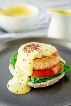 a plate with a sandwich on it and sauce drizzled over the top