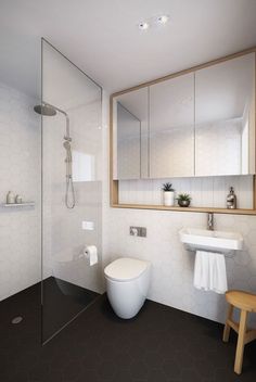 a bathroom with a toilet, sink and shower in it's own area is shown