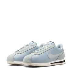 The ultimate street-style sneaker. Modeled initially as a running shoe, the Nike Cortez has become a street icon for urban neighborhoods worldwide. The lightweight feel, underfoot cushioning, and effortless style are only some of the reasons why this shoe is still so popular today. This iteration features a classic black Swoosh with a matching heel and blue midsole stripe. Inspired by the 72 original, the foam midsole with iconic wedge insert delivers comfort from the get-go. Leather upper is e Soccer Shop, Sneakers Street Style, Nike Cortez, Nike Jordan, Sports Equipment, Running Shoe, Work Casual, Dress With Boots, Shoe Shop