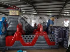 an inflatable slide is shown with people standing on the slides and other items