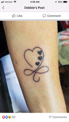 a small heart tattoo on the arm