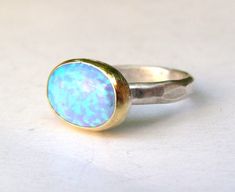 OPAL RING You are looking at a beautiful HAND MADE silver and gold ring with opal stone. The stone are setting in 14k gold bazel It is impressive, powerful and very beautiful ring. Made to order any size.. This ring can be made to order in any size. Please note your desired size in the message to seller area at checkout. size stone is 10mmX14mm width ring: 3mm Come in a gift box. Fallow me on facebook for newest updates. http://www.facebook.com/pages/Orit-Naar-jewelry/174677569247132?sk=wall Unique Large Stone Opal Ring For Gift, Unique Opal Ring With Large Stone For Gift, Elegant Unique Opal Ring Gift, One Of A Kind Oval Opal Ring For Anniversary, October Stone, Blue Opal Ring, Solitaire Rings, Birthday Ring, Oval Ring