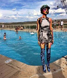 a woman standing in front of a swimming pool