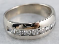 a close up of a wedding ring with diamonds