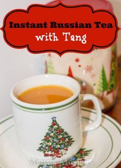 a cup of russian tea on a saucer next to a canister with the words instant russian tea with tang