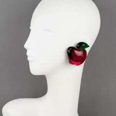 This is part of Chairish’s Costume Jewelry assortment.  Whimsical oversized Lucite clip-on earrings designed by Harriet Bauknight for Kaso in the 1980s. They feature a dimensional apple shape, all carved with ruby red and emerald green colors and mirror-textured effects.  The Kaso paper sticker was removed, but the gray background and the specific rotating clip back are unmistakable brand signatures.  Measurements: 2.19 in long (5.5 cm) x 1.88 in wide (4.8 cm) x 0.69 in deep (1.7 cm).  About: Ha Redesign Ideas, Apple Shape, Lucite Jewelry, Apple Shaped, Paper Sticker, Winter 2024, Clip Earrings, Green Apple, Gray Background