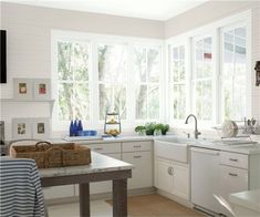 a kitchen with blue walls and white cabinets