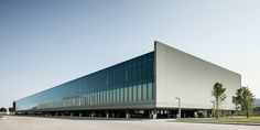 an empty parking lot in front of a large building