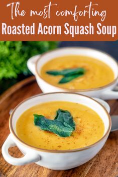 two white bowls filled with roasted acorn squash soup on top of a wooden cutting board