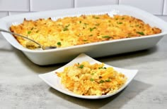 a casserole dish is shown with a serving spoon in front of the casserole