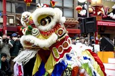 a lion dance costume is being displayed in front of a crowd at the chinese new year celebration