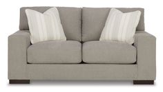 a gray couch with two pillows on it