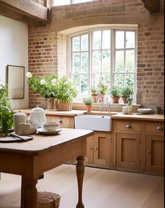 a kitchen filled with lots of wooden furniture and potted plants next to a window