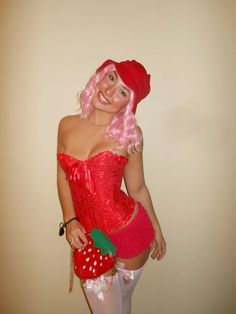 a woman dressed in red and white posing for the camera with a strawberry on her chest