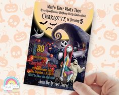 a hand holding up a halloween party card