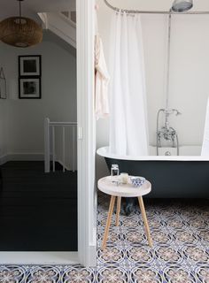 a bath tub sitting next to a white toilet in a bathroom