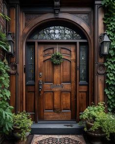 a wooden door surrounded by greenery and potted plants