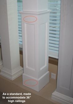 there are two tall white pedestals in the corner of this room, and one has an orange circle on it