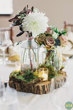 a table with flowers and candles on it