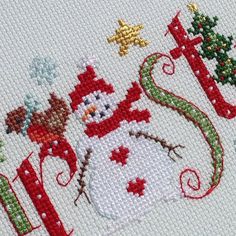 a cross stitch christmas card with a snowman