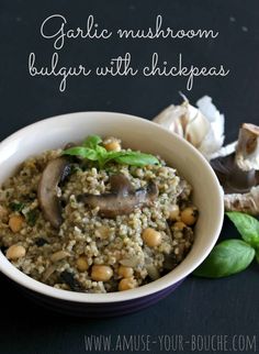 garlic mushroom bulgur with chickpeas in a white bowl on a black surface