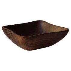 a wooden bowl on a white background