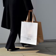 a woman in black coat carrying shopping bags