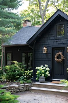 a black house with a wreath on the front door