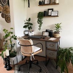 a home office with plants on the wall