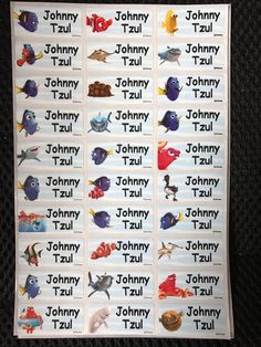 the names of different disney characters on a wall hanging from a black curtain in a room