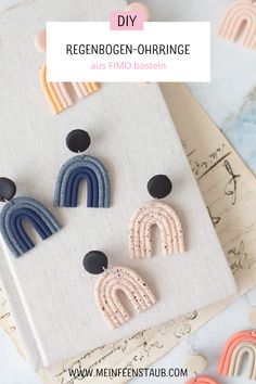 three pairs of earrings on top of a book