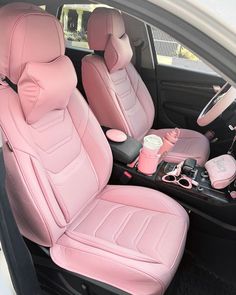 the interior of a car with pink leather seats and cup holders on the back row