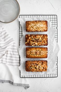 someone reaching for banana bread on a cooling rack