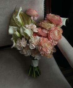 a bouquet of flowers sitting on top of a chair