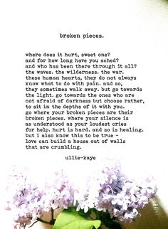 a vase filled with purple flowers sitting on top of a table next to a poem