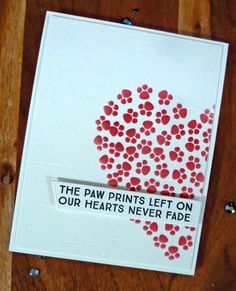 the paw prints left on our heart's never fade card is made with stamping ink