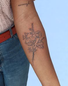 a woman with a flower tattoo on her arm