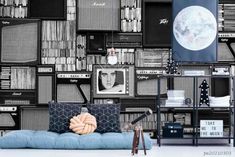 a living room with bookshelves and televisions on the wall in black and white