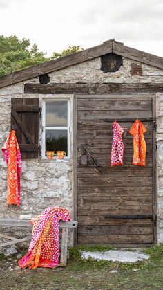 an old stone building with clothes hanging outside