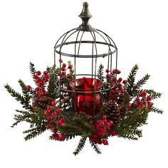 a birdcage filled with red candles and greenery