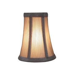 a lamp that is on top of a white tablecloth with a brown and black striped shade