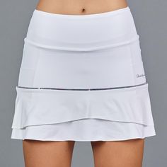 Active Lifestyle ApparelDesigned and made in USA. DESCRIPTION White skort with a print accent - great fitting two tiered design, banded waistband, back pockets, tummy control waist effect. Discreet mesh pockets & inverted ball-pocket on the shorts. DETAILS & FIT Fitted at hip, two loose flanges, tummy control waistband and fitted short. Length: 15” (+/- 1”) FABRIC & CARE 90% Polyester, 10% Spandex 90% Nylon, 10% Spandex Machine wash cold, do not bleach, tumble dry low, cool iron, do Summer White Bottoms With Contoured Waistband, White Bottoms With Contoured Waistband For Summer, White Fitted Bottoms With Contoured Waistband, Fitted White Bottoms With Contoured Waistband, White Fitted Bottoms With Banded Waist, White Stretch Tiered Skirt, White Tennis Skirt, White Skort, Tennis Skirts